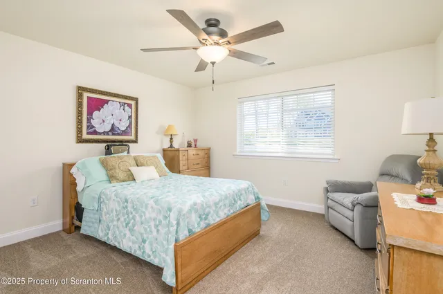 a bedroom with a bed couch and a window