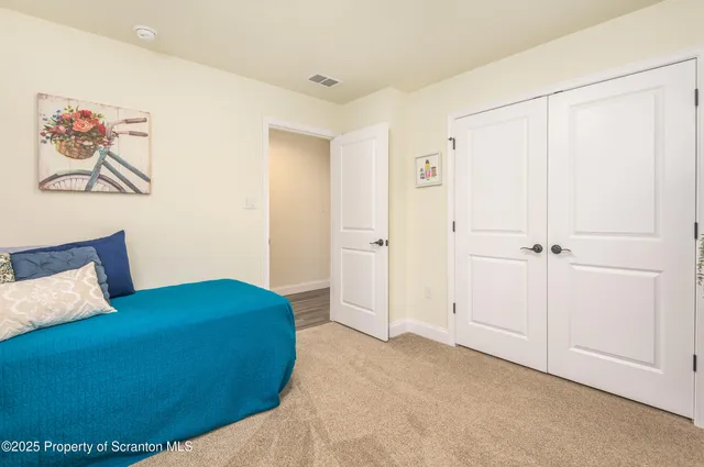 a bedroom with a bed and a painting on the wall