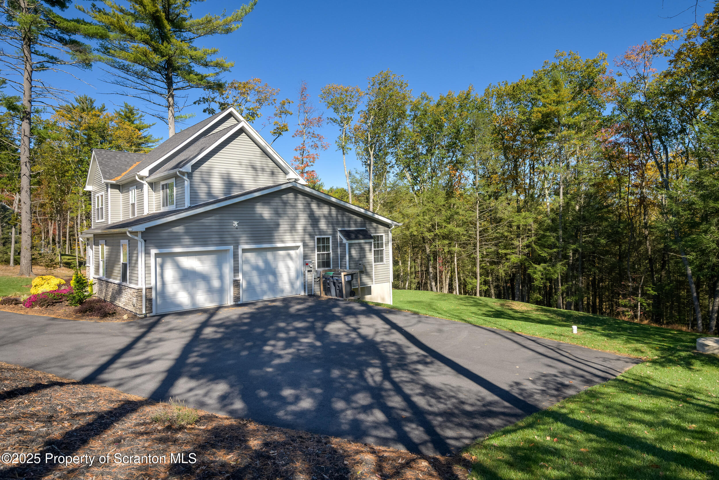 131 Chinaberry Way Kunkletown, PA 18058 - Photo 4 of 48 a view of a white house next to a yard with big trees