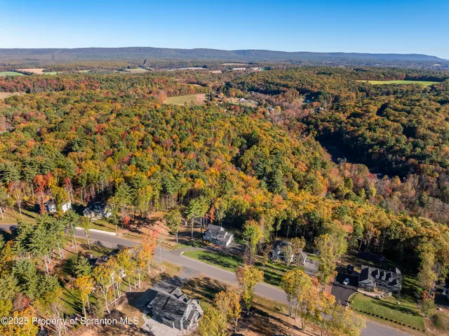 an aerial view of residential building and lake