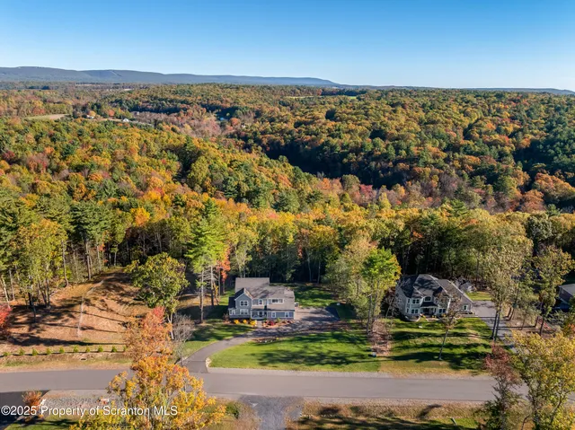 a front view of a house with a big yard