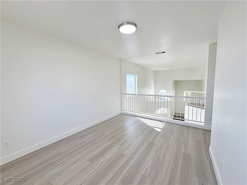 9416 Moon Splash Court Las Vegas, NV 89129 - Photo 23 of 47 Unfurnished room featuring baseboards and light wood-type flooring