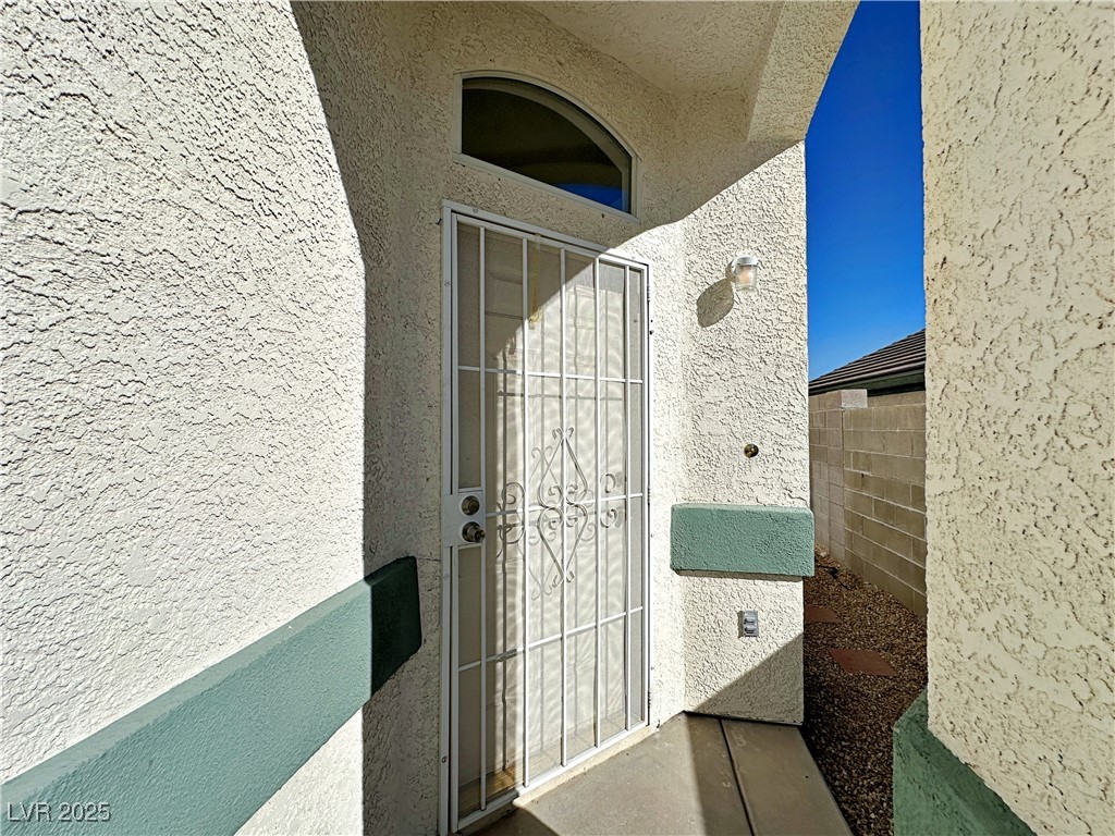9416 Moon Splash Court Las Vegas, NV 89129 - Photo 3 of 47 Entrance to property featuring stucco siding