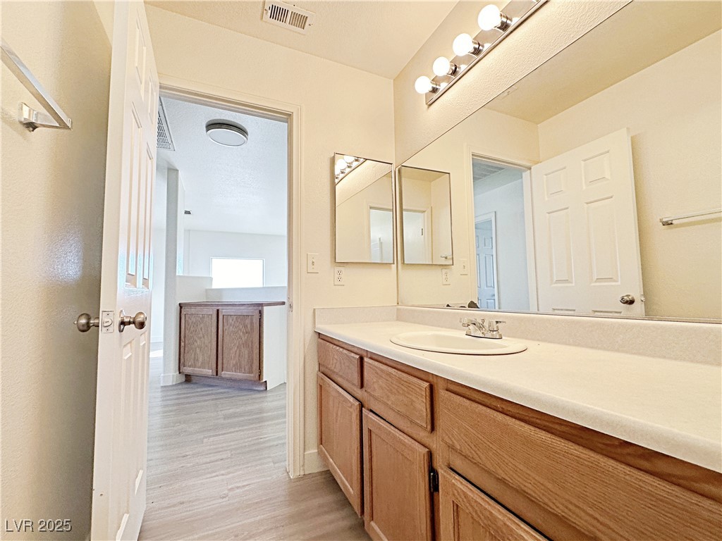 9416 Moon Splash Court Las Vegas, NV 89129 - Photo 33 of 47 Bathroom featuring vanity and light wood-style floors