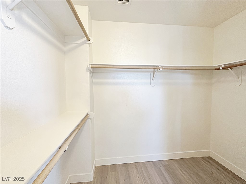 9416 Moon Splash Court Las Vegas, NV 89129 - Photo 40 of 47 Walk in closet with light wood finished floors