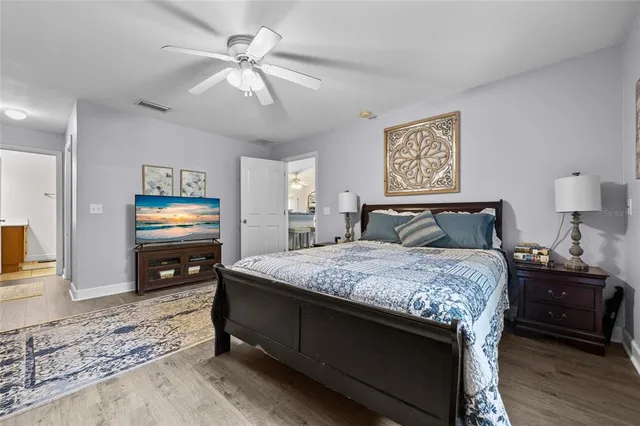 a bedroom with a bed and a tv