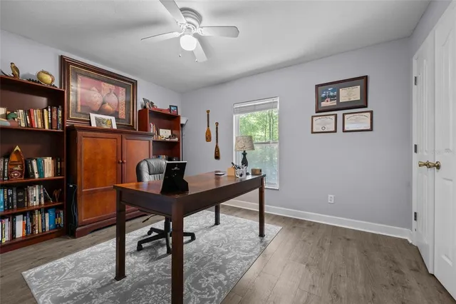 a view of a workspace with furniture and a bookshelf