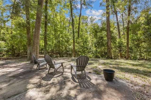 a view of a backyard with table and chairs