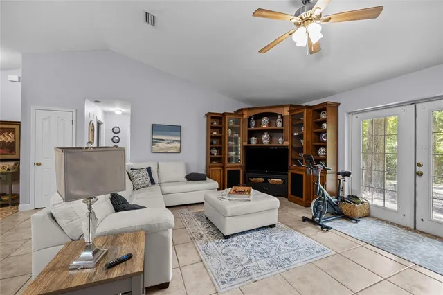a living room with furniture a rug and a chandelier