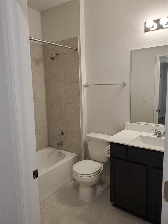 6404 Gunflint Drive Austin, TX 78747 - Photo 7 of 21 A well-appointed bathroom featuring a tiled shower, bathtub, and a modern vanity.