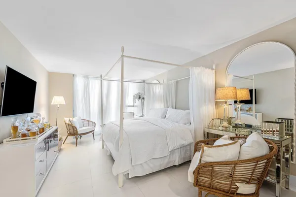 a bedroom with furniture and a flat screen tv