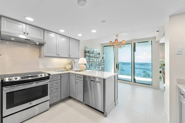 a kitchen with stainless steel appliances a stove sink and cabinets