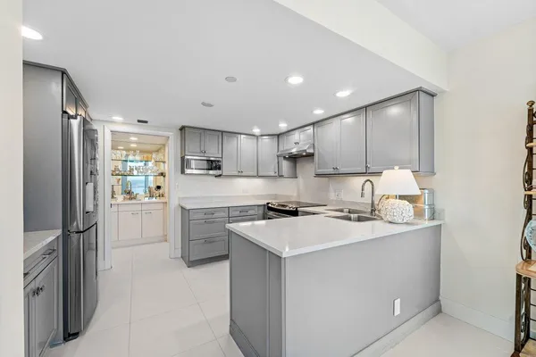 a kitchen with a sink stainless steel appliances and cabinets