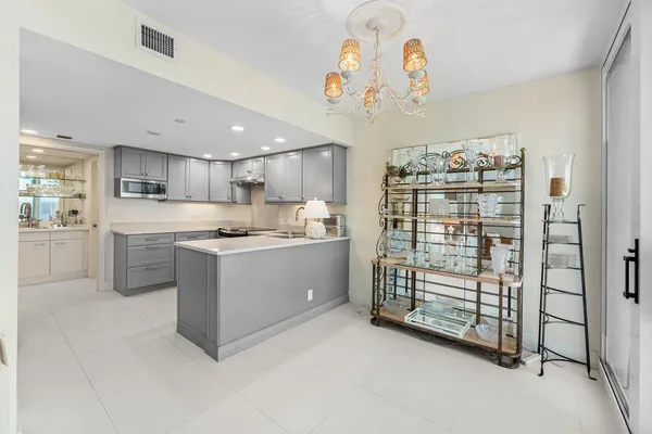 a kitchen with a refrigerator and a sink