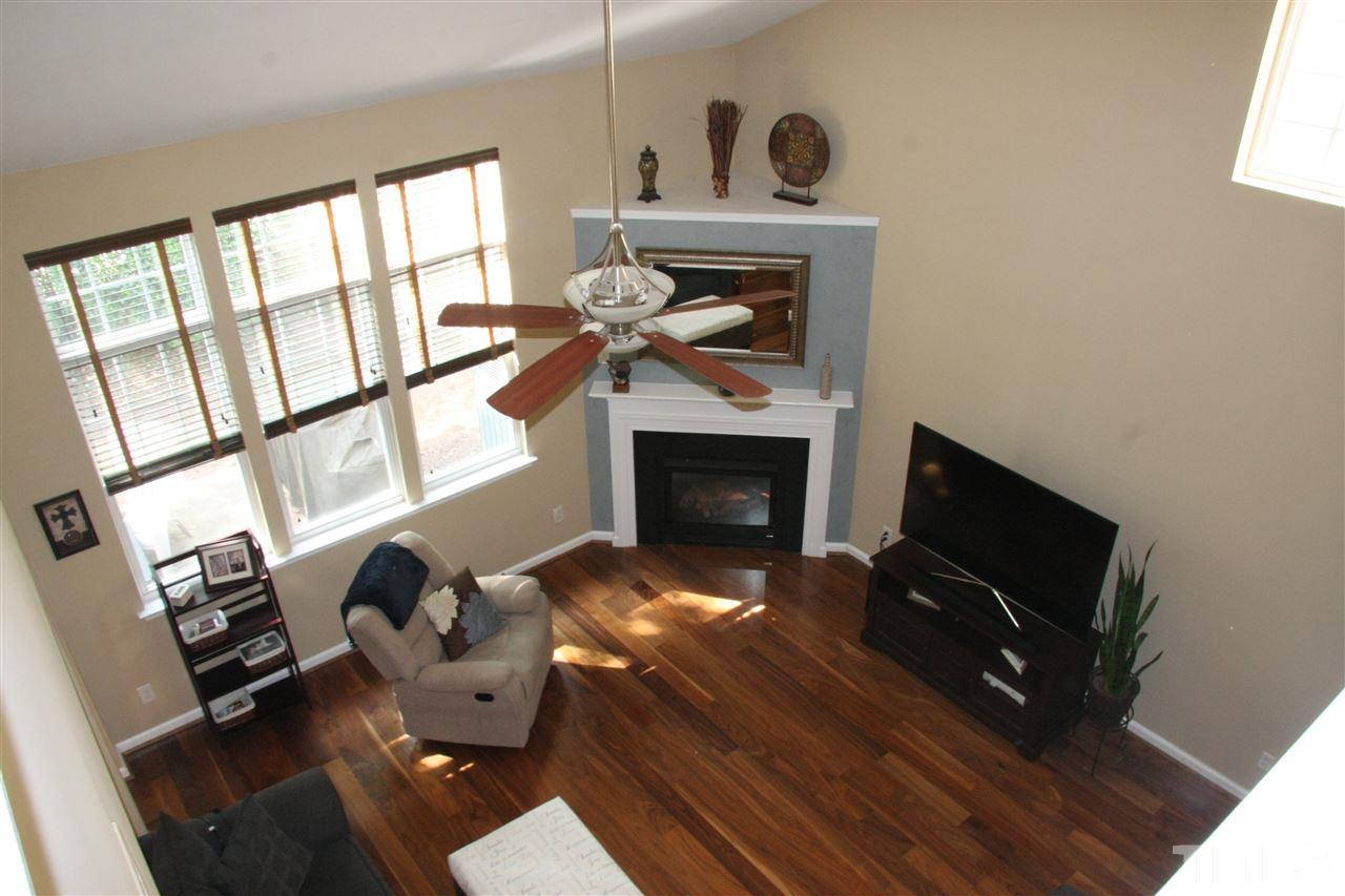 8305 Rubblestone Path Raleigh, NC 27613 - Photo 14 of 24 a living room with furniture fireplace and flat screen tv