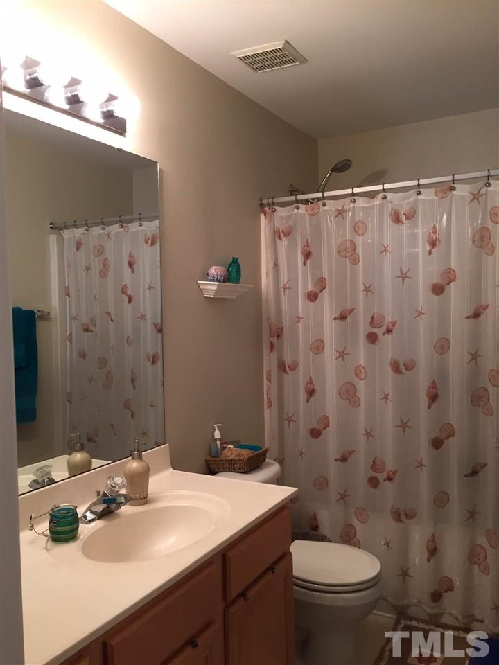 8305 Rubblestone Path Raleigh, NC 27613 - Photo 16 of 24 a bathroom with a sink toilet and shower