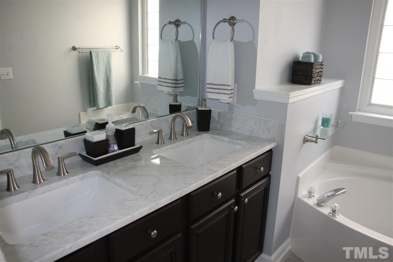 8305 Rubblestone Path Raleigh, NC 27613 - Photo 18 of 24 a kitchen with a sink dishwasher and a refrigerator