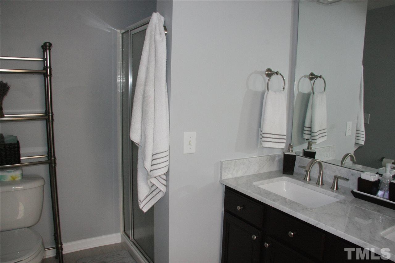 8305 Rubblestone Path Raleigh, NC 27613 - Photo 21 of 24 a bathroom with a double vanity sink and a mirror