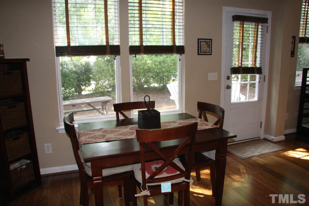8305 Rubblestone Path Raleigh, NC 27613 - Photo 8 of 24 a view of a dining room with furniture window and wooden floor