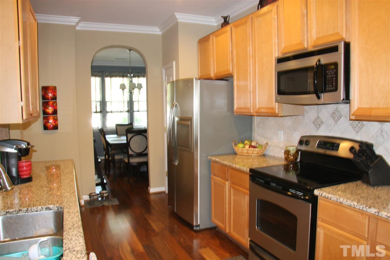 8305 Rubblestone Path Raleigh, NC 27613 - Photo 9 of 24 a kitchen with a stove and a microwave