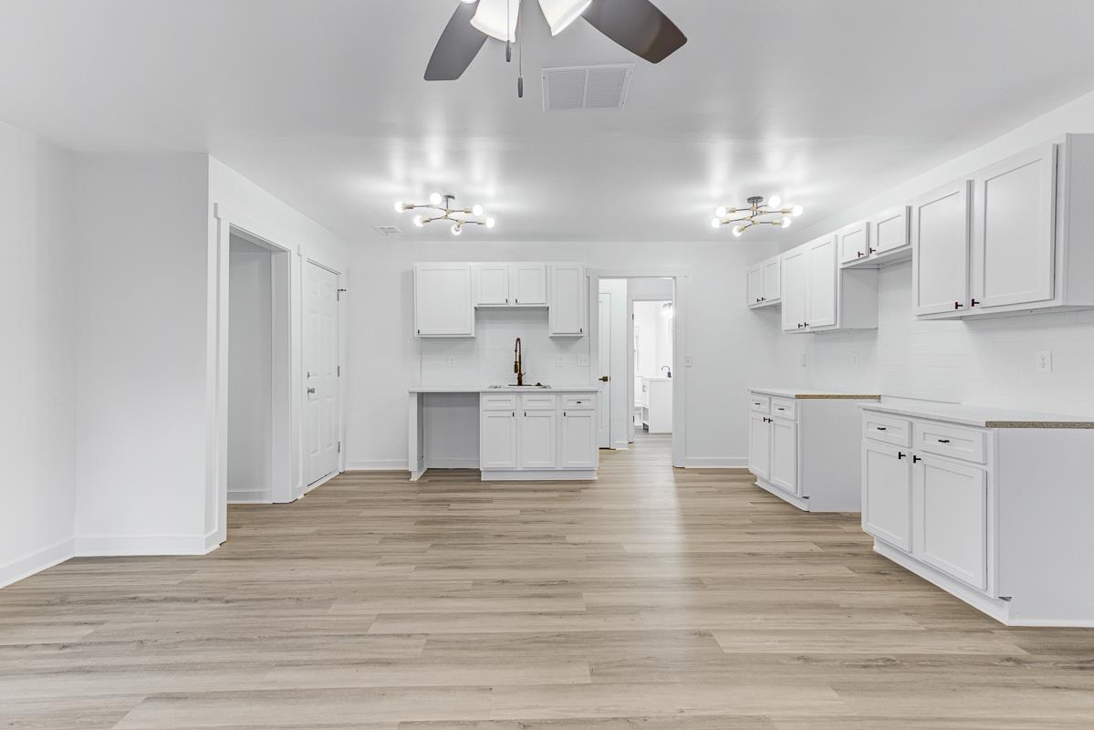 3512 Wilshire Road Memphis, TN 38111 - Photo 3 of 19 a view of a kitchen with a sink dishwasher a kitchen counter top space and cabinets