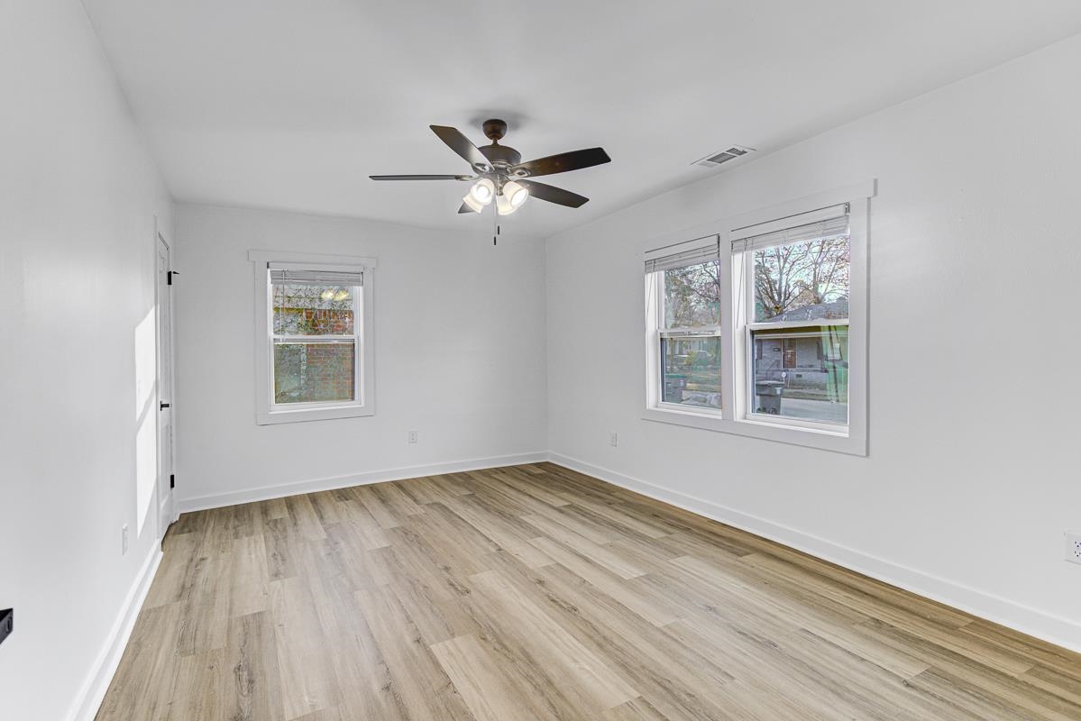 3512 Wilshire Road Memphis, TN 38111 - Photo 6 of 19 a view of empty room with wooden floor and fan
