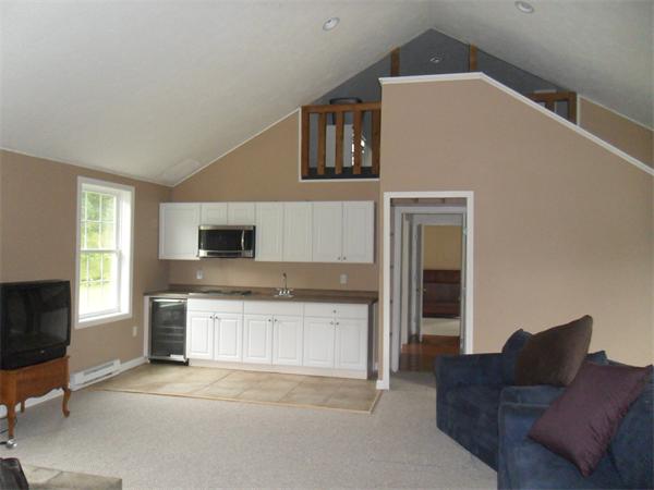 706 Main Street Boxford, MA 01921 - Photo 16 of 26 a living room with stainless steel appliances furniture a fireplace and a flat screen tv