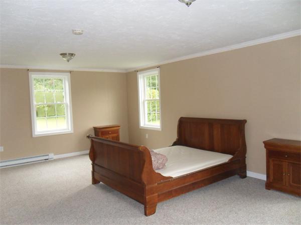 706 Main Street Boxford, MA 01921 - Photo 19 of 26 a bedroom with a bed and window