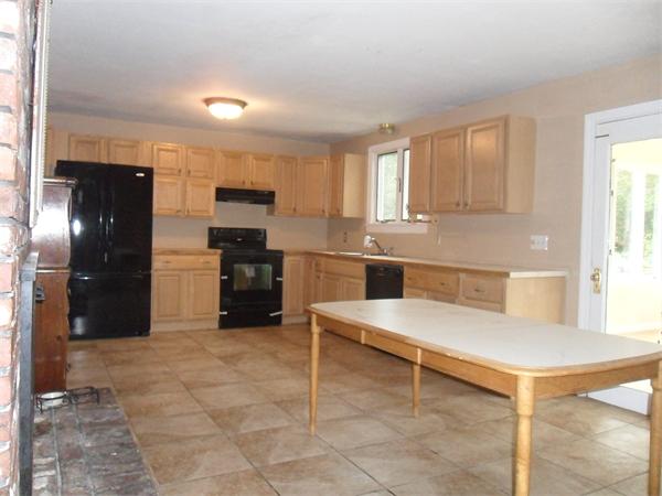 706 Main Street Boxford, MA 01921 - Photo 2 of 26 a kitchen with a refrigerator and a stove top oven