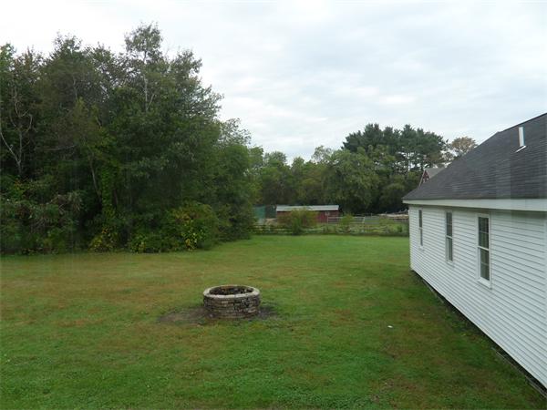 706 Main Street Boxford, MA 01921 - Photo 25 of 26 a backyard of a house with lots of green space