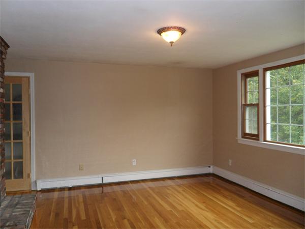 706 Main Street Boxford, MA 01921 - Photo 6 of 26 an empty room with wooden floor and windows