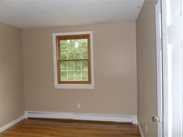 706 Main Street Boxford, MA 01921 - Photo 9 of 26 a view of an empty room with wooden floor and a window
