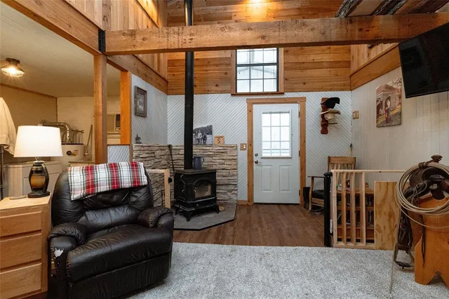 a living room with furniture a rug and a flat screen tv