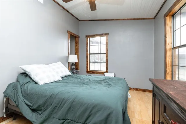a bed sitting in a bedroom next to a window