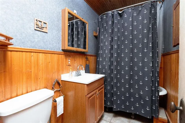 a bathroom with a sink a mirror and a toilet