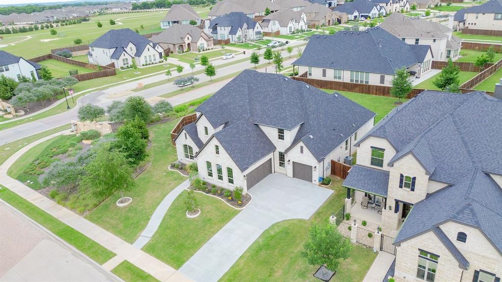 1316 Limestone Ridge Road Mansfield, TX 76063 - Photo 34 of 40 Two-story residence featuring a light-colored brick facade, dark gray roofing, and an attached two-car garage