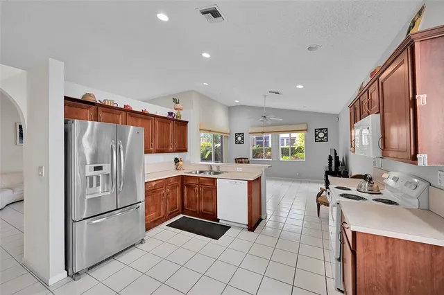 a kitchen with stainless steel appliances a stove a sink a refrigerator and cabinets