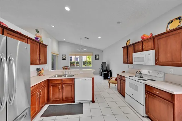 a kitchen with a sink appliances and cabinets