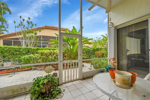 a porch with a table and chairs in patio
