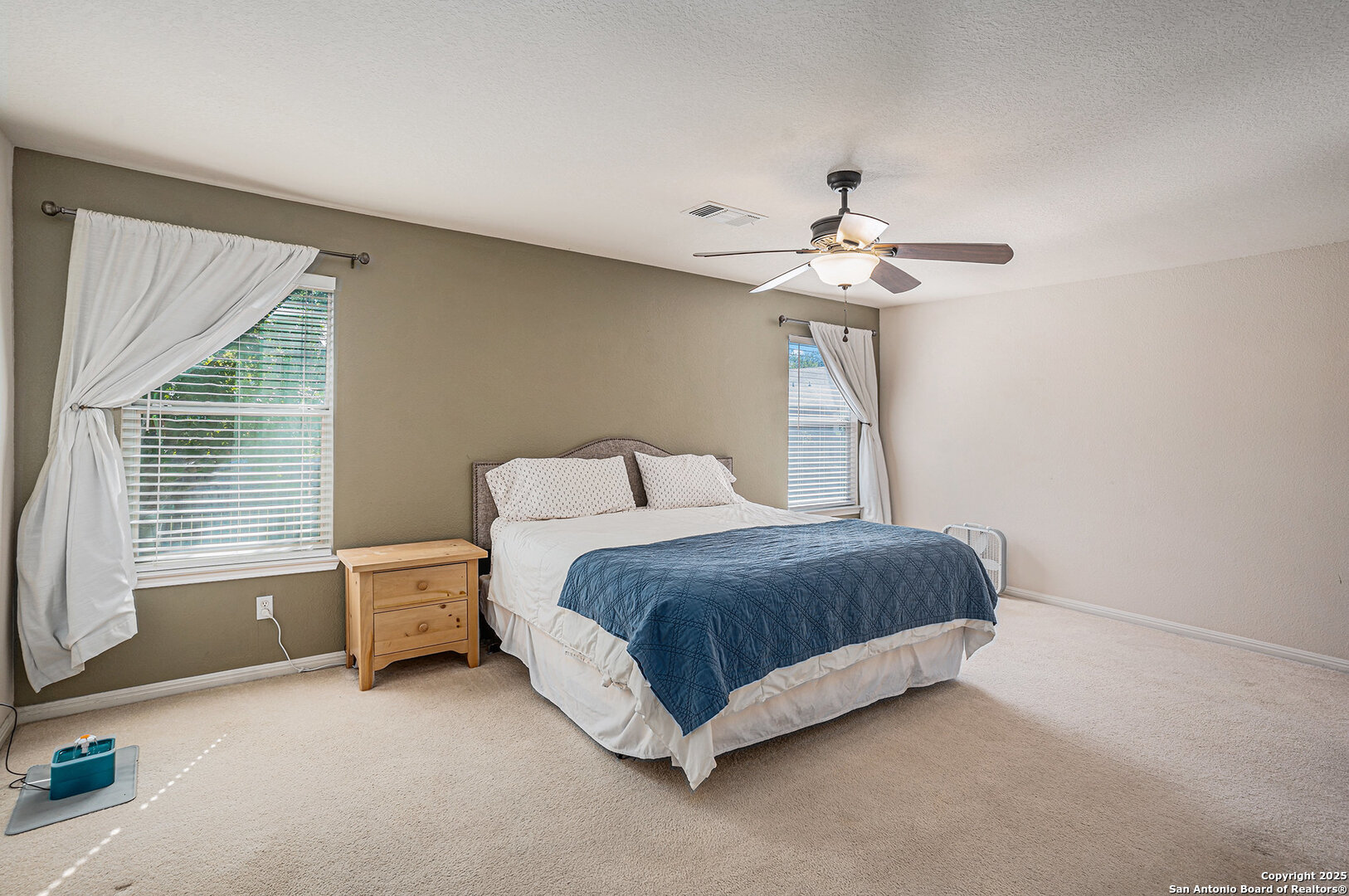 117 Hidden Fawn Cibolo, TX 78108 - Photo 15 of 25 a spacious bedroom with a bed and a chandelier