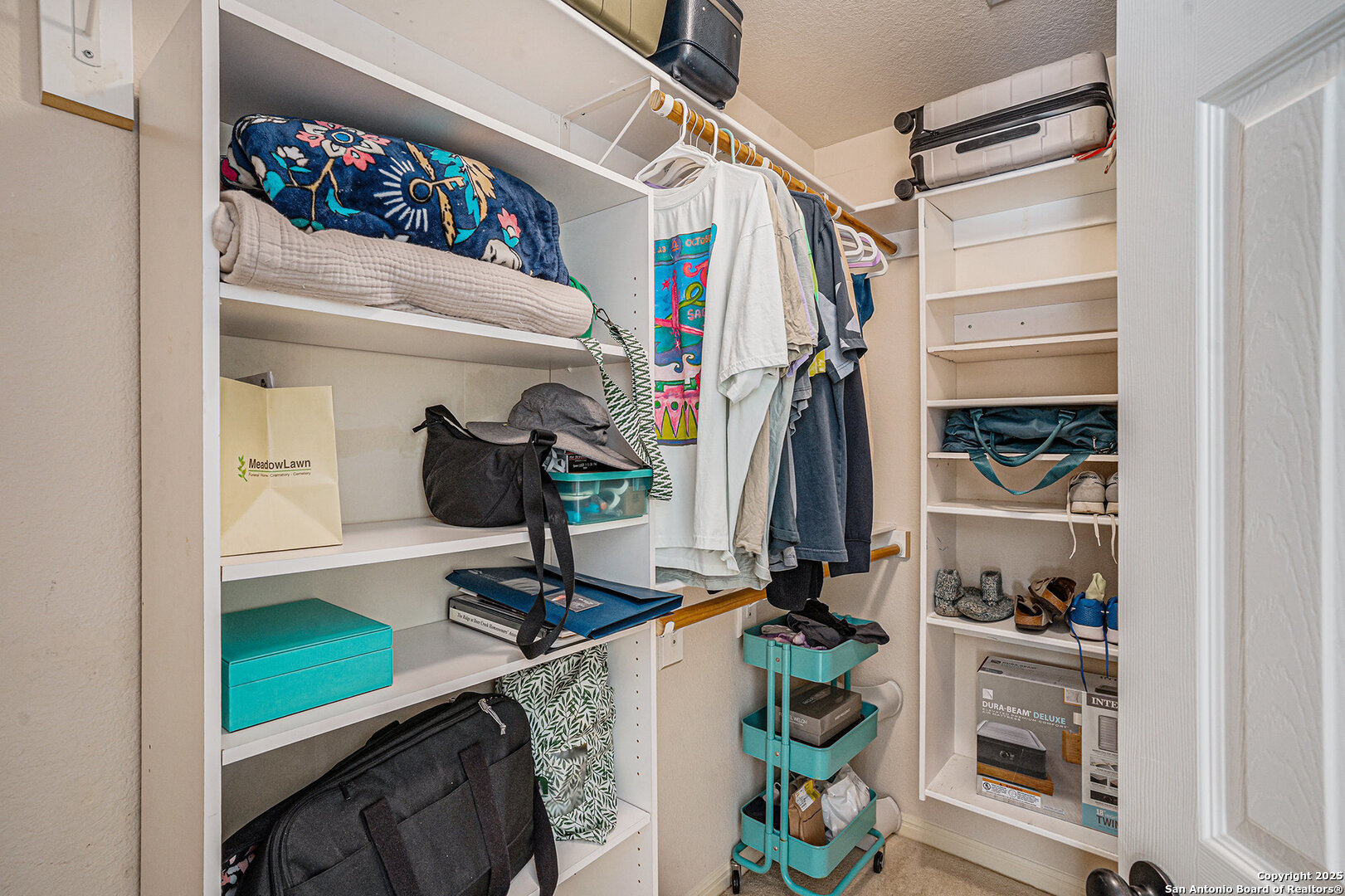 117 Hidden Fawn Cibolo, TX 78108 - Photo 17 of 25 a view of walk in closet with clothes and shoes