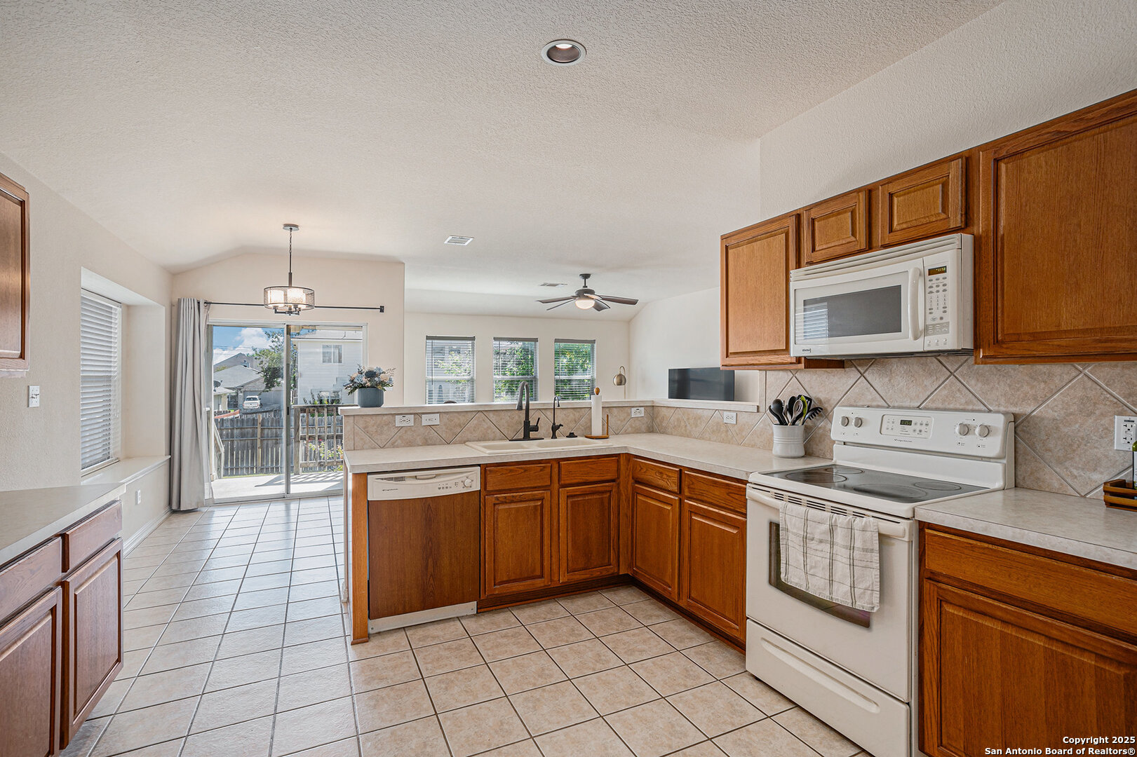 117 Hidden Fawn Cibolo, TX 78108 - Photo 10 of 25 a kitchen with a sink stove and cabinets