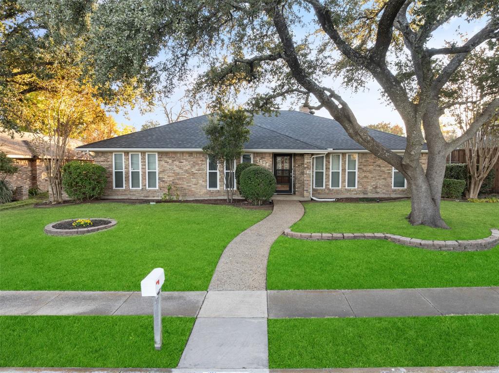 a front view of a house with a yard table and chairs