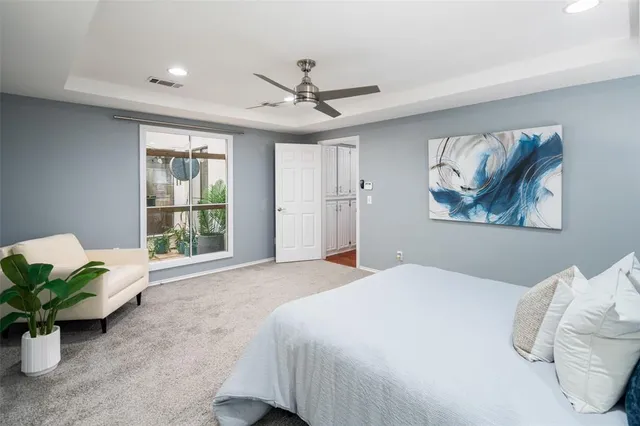 a spacious bedroom with a bed and a window