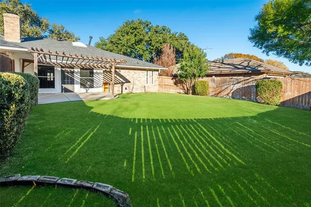 a view of a house with a backyard