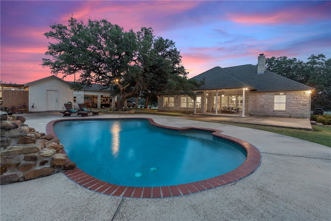 550 Gatlin Creek Road Dripping Springs, TX 78620 - Photo 1 of 1 a view of a swimming pool with an outdoor seating
