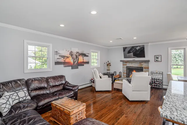 a living room with fireplace furniture and a window