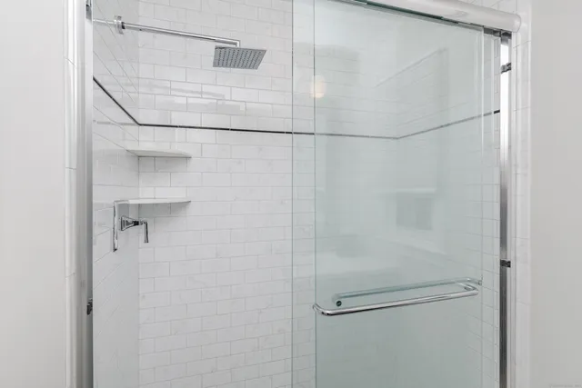 a bathroom with a glass shower door