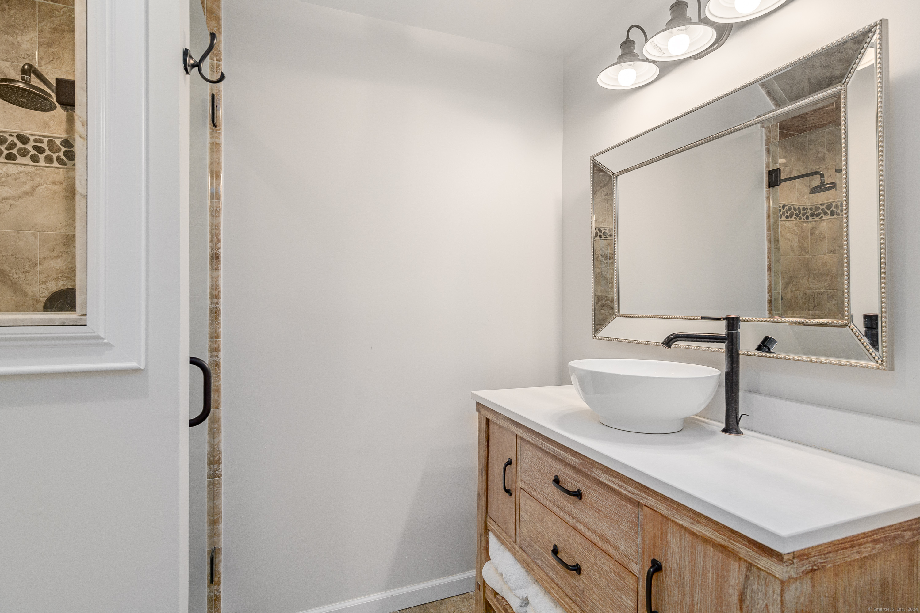 22 Brookside Trail New Milford, CT 06776 - Photo 21 of 40 a bathroom with a sink a toilet and mirror