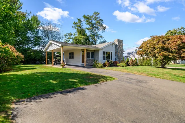 a front view of house with yard and green space